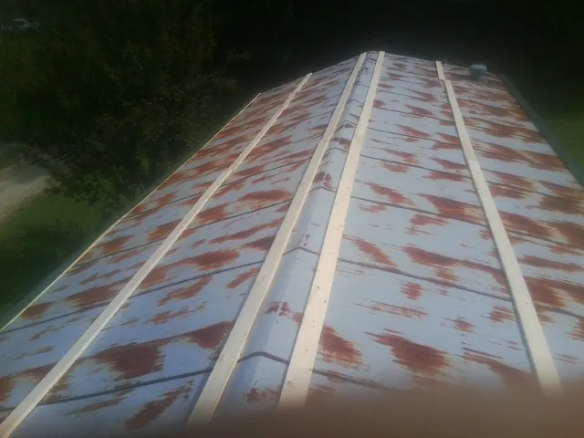 Rusted metal roof panels with new wood purlins before replacement — Storm Damage Roof Repair in Guin by Roofing Brothers